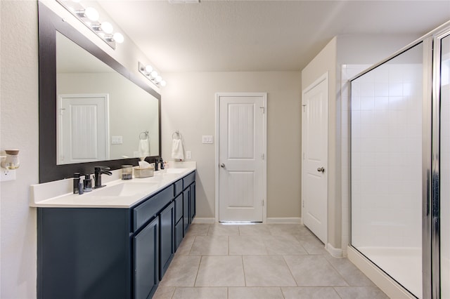 bathroom featuring vanity, a shower with shower door, a textured ceiling, and tile patterned flooring