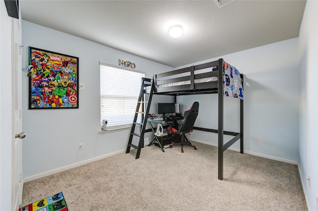 bedroom featuring a textured ceiling and carpet flooring