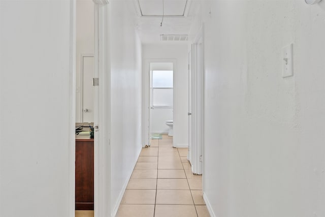 hallway with light tile patterned floors