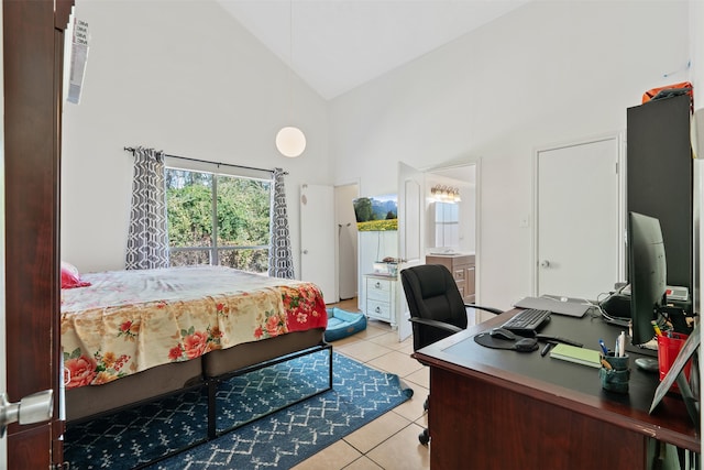 bedroom with light tile patterned flooring, ensuite bathroom, and high vaulted ceiling