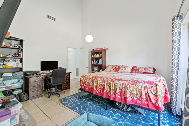 tiled bedroom with a high ceiling