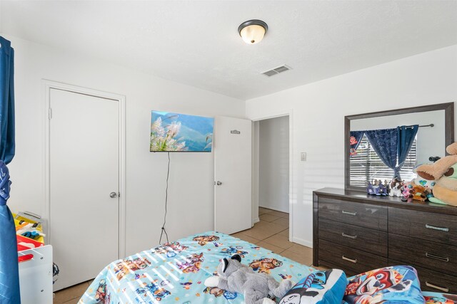 bedroom featuring light tile patterned flooring