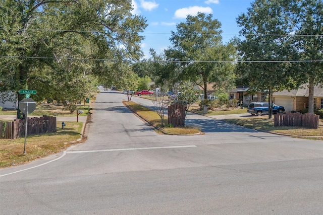 1603 Cantrell Blvd, Conroe, TX 77301 - view of asphalt road with curbs and traffic signs