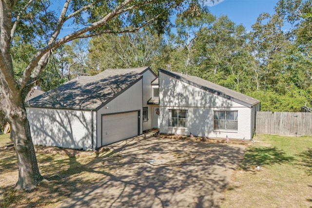 view of front facade with a garage and a front lawn