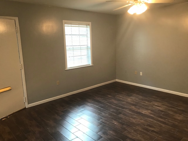 empty room featuring dark hardwood / wood-style floors and ceiling fan