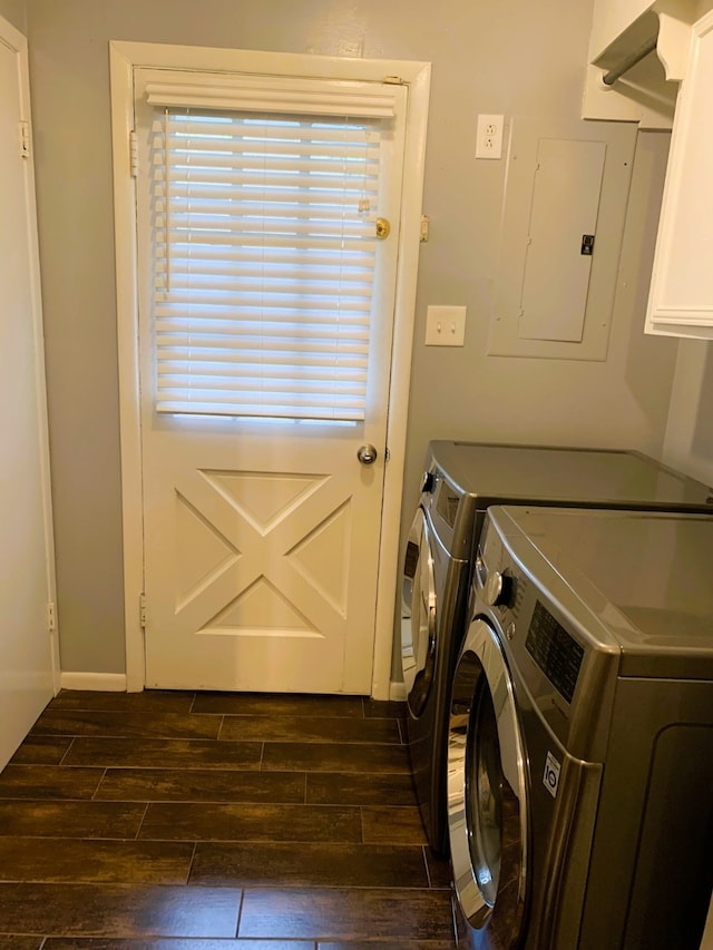 clothes washing area featuring cabinets, dark hardwood / wood-style floors, electric panel, and washing machine and dryer