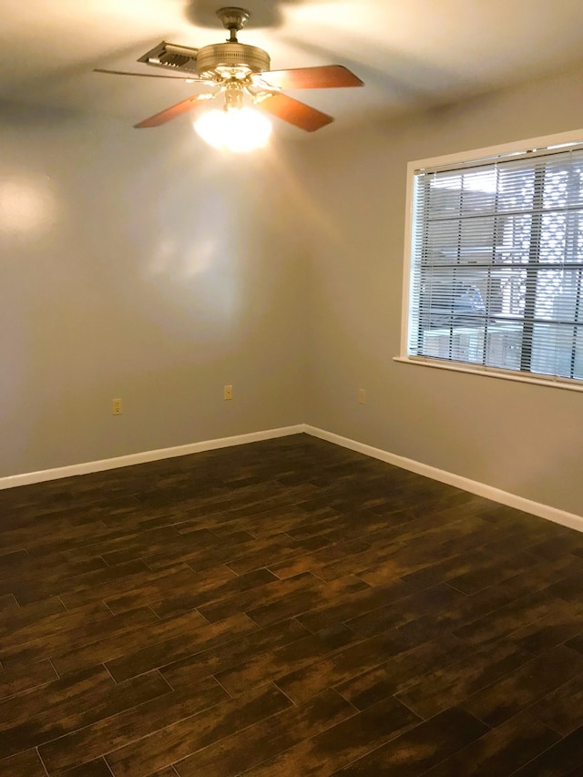 empty room with dark wood-type flooring and ceiling fan