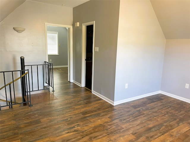 additional living space with lofted ceiling and dark wood-type flooring