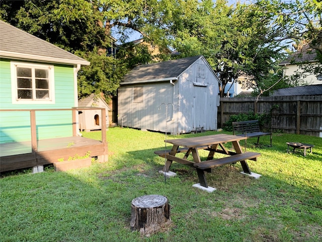 view of yard featuring a shed and a wooden deck