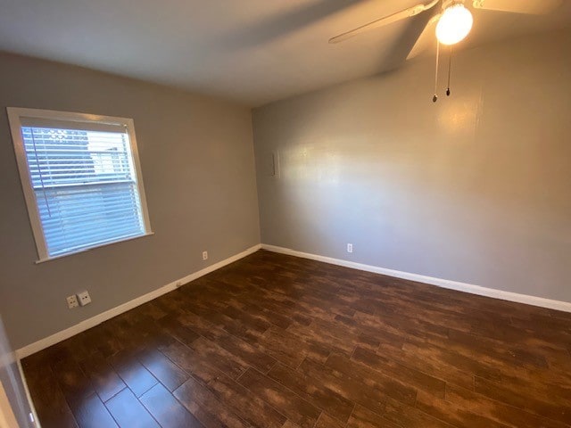 empty room featuring dark hardwood / wood-style floors and ceiling fan