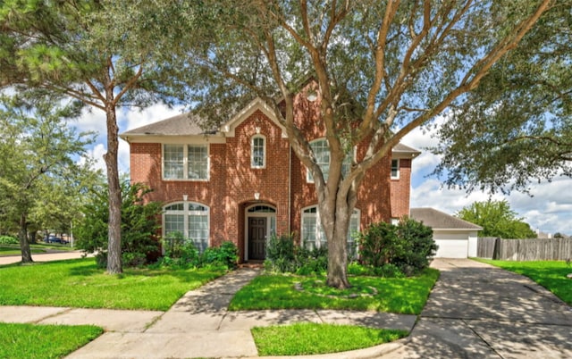 view of front facade with a front yard and a garage