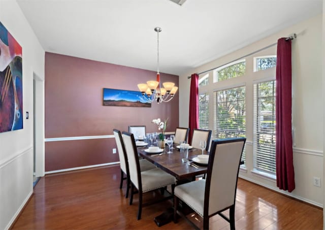 dining room featuring a chandelier and dark hardwood / wood-style floors