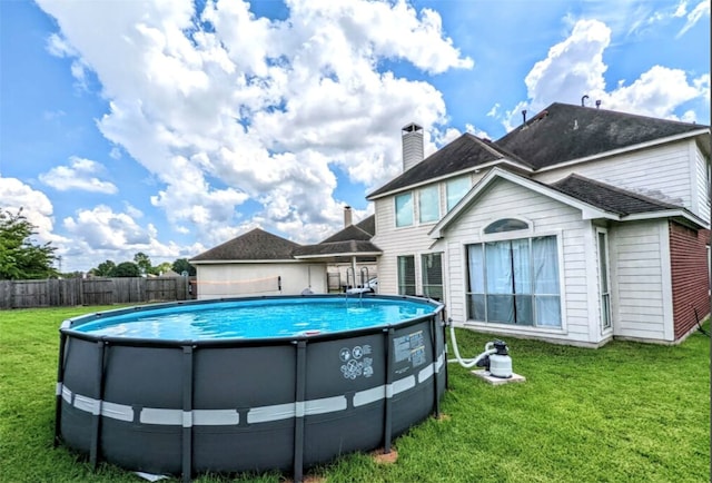 view of pool featuring a lawn