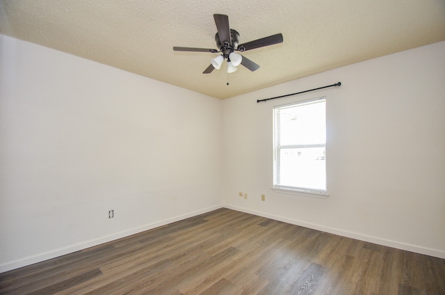 unfurnished room featuring dark wood-type flooring, a textured ceiling, and ceiling fan