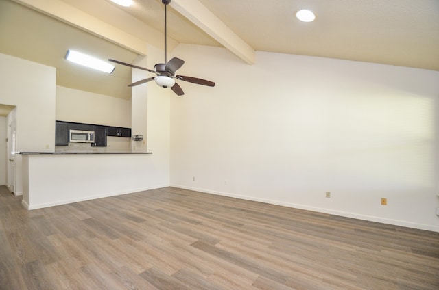 unfurnished living room featuring hardwood / wood-style flooring, beamed ceiling, high vaulted ceiling, and ceiling fan