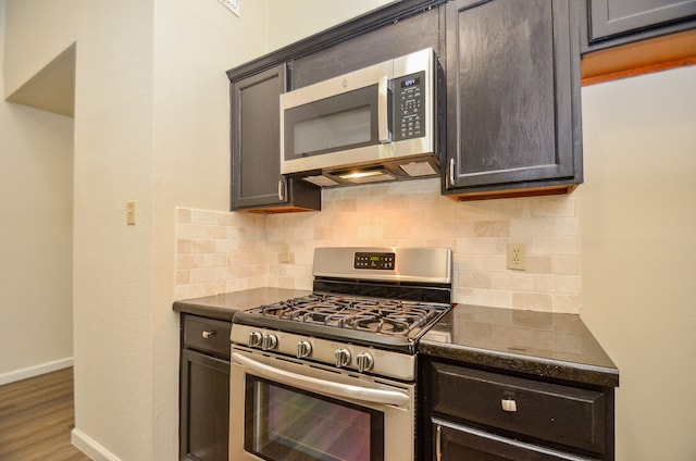 kitchen featuring decorative backsplash, hardwood / wood-style floors, and stainless steel appliances