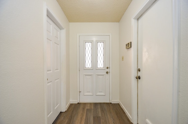 entryway featuring a textured ceiling and dark hardwood / wood-style flooring