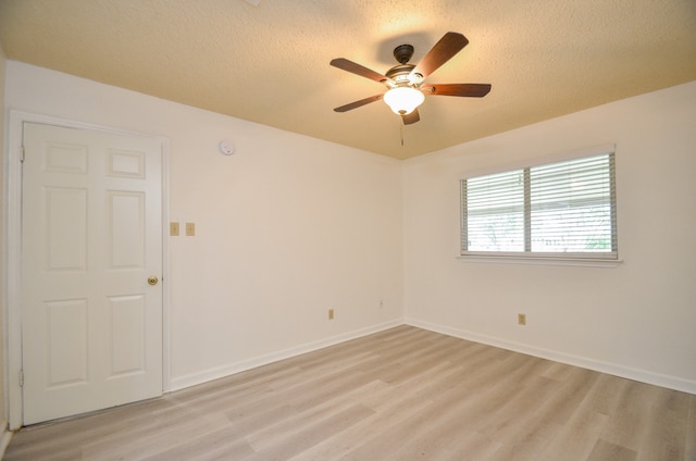 empty room with light hardwood / wood-style flooring, a textured ceiling, and ceiling fan