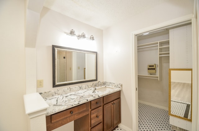 bathroom with vanity and a textured ceiling