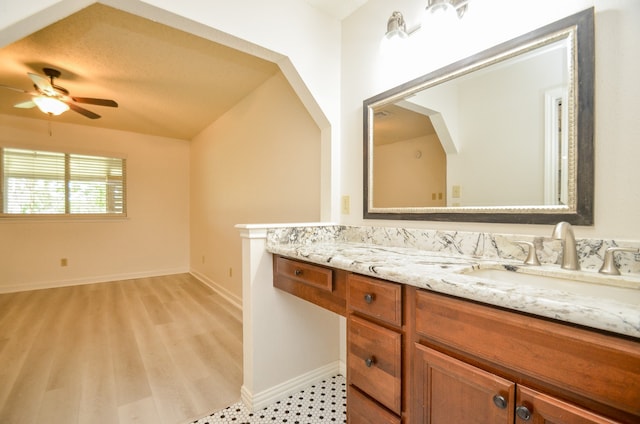 bathroom featuring vanity, hardwood / wood-style floors, a textured ceiling, and ceiling fan