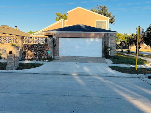 view of front of property with concrete driveway and an attached garage