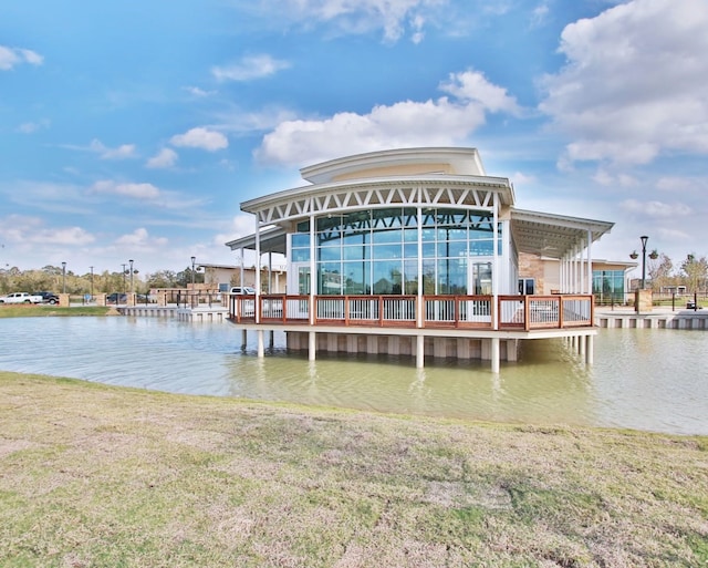 view of dock featuring a yard and a water view