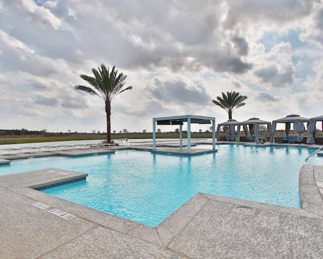 pool featuring a patio and a gazebo