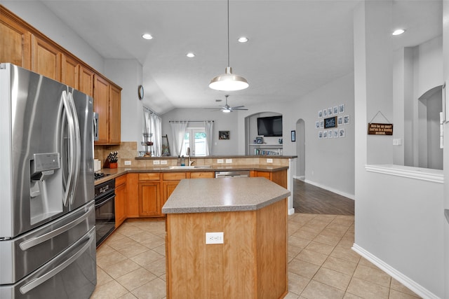 kitchen with a kitchen island, appliances with stainless steel finishes, light tile patterned floors, and ceiling fan