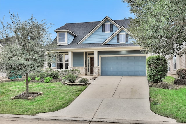 craftsman-style house featuring covered porch, a front lawn, and a garage