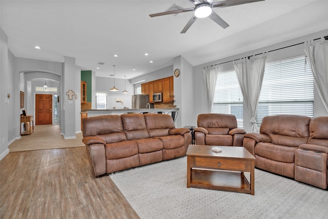 living room featuring light hardwood / wood-style floors and ceiling fan