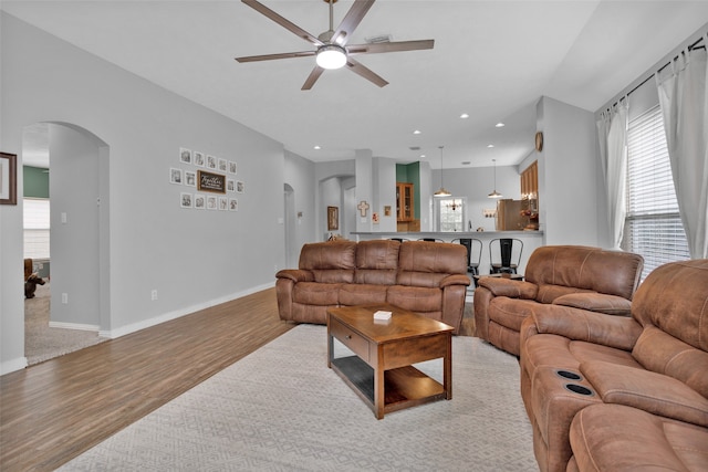 living room featuring light wood-type flooring and ceiling fan