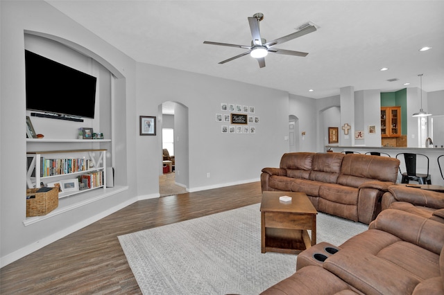 living room featuring sink, wood-type flooring, and ceiling fan