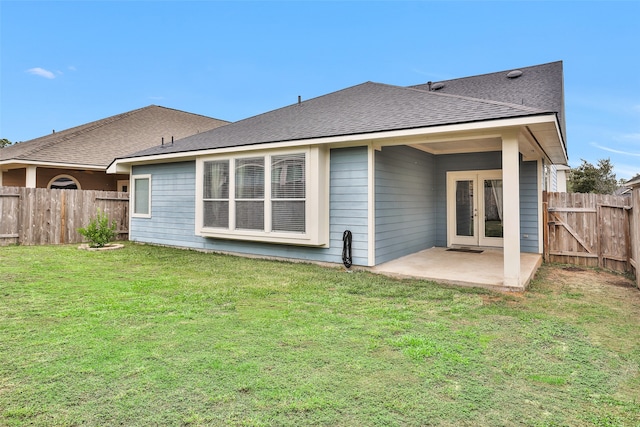 rear view of property featuring a patio and a lawn