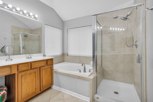 bathroom featuring vanity, tile patterned flooring, plus walk in shower, and vaulted ceiling