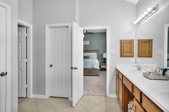 bathroom with vanity, tile patterned floors, and a towering ceiling