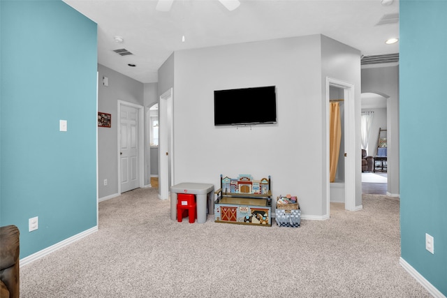 playroom featuring light colored carpet and ceiling fan