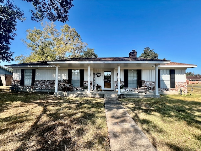 ranch-style home featuring a porch and a front lawn