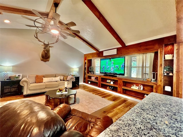 living room with ceiling fan, lofted ceiling with beams, and hardwood / wood-style floors