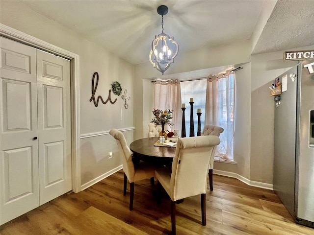 dining area featuring a chandelier and hardwood / wood-style floors