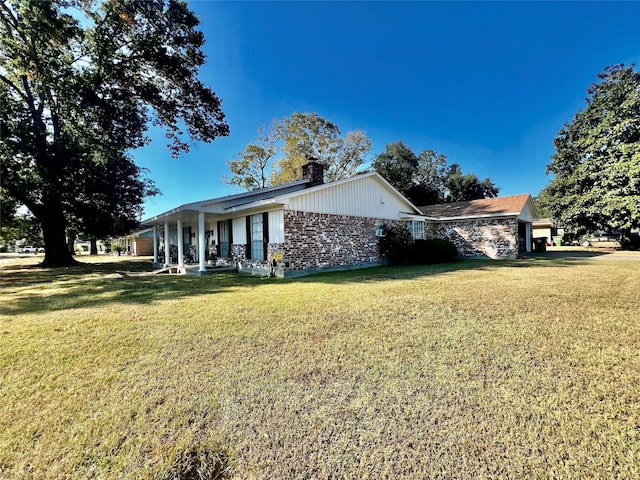 view of side of property with a yard