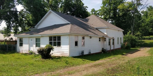 rear view of property featuring a yard