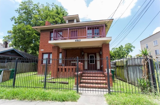 view of front facade featuring a front lawn and covered porch