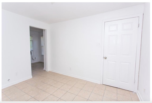 spare room featuring light tile patterned floors