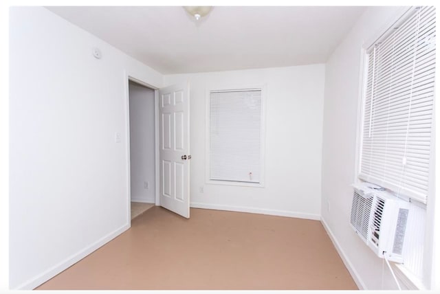 unfurnished room featuring concrete floors and cooling unit