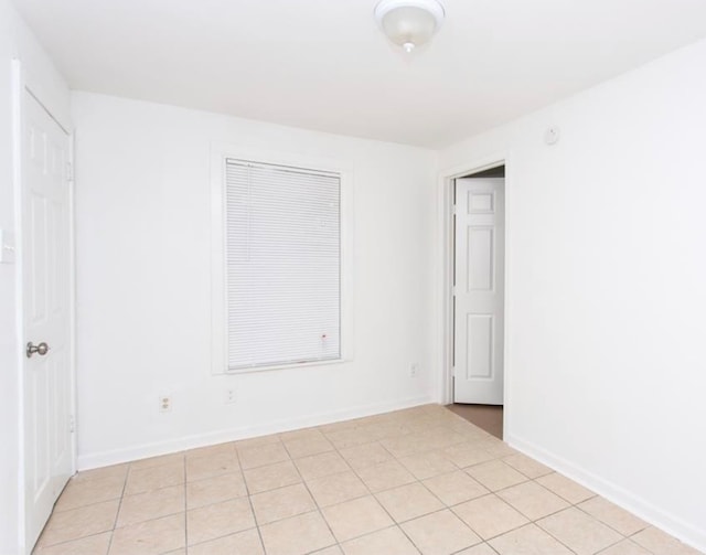 unfurnished room featuring light tile patterned floors