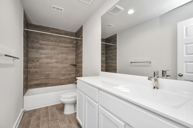 full bathroom with toilet, tiled shower / bath combo, and vanity