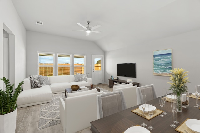 living room with lofted ceiling, light hardwood / wood-style flooring, and ceiling fan