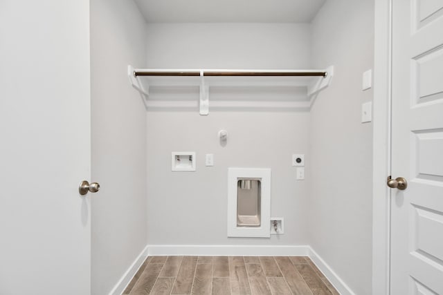 laundry room with hookup for a washing machine, hardwood / wood-style flooring, hookup for an electric dryer, and gas dryer hookup