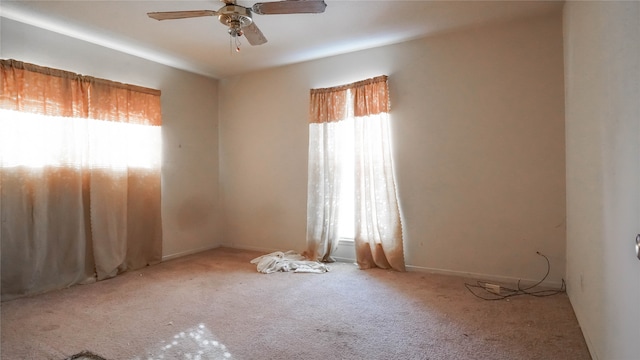 empty room featuring light carpet and ceiling fan