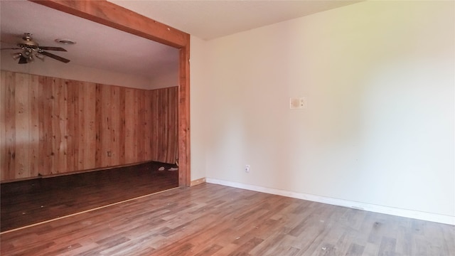 empty room featuring ceiling fan and hardwood / wood-style floors